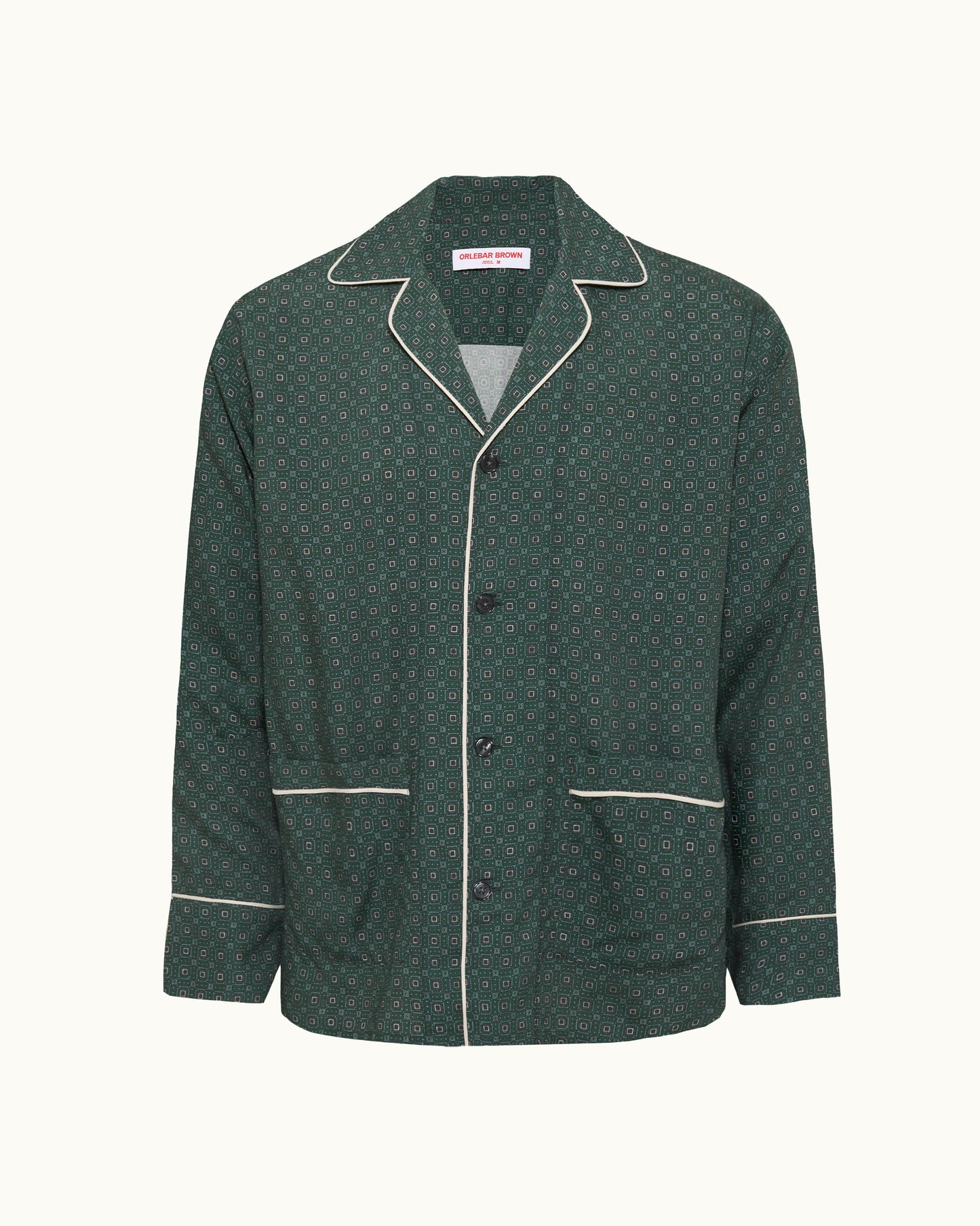 Green patterned jacket with white piping on a white background