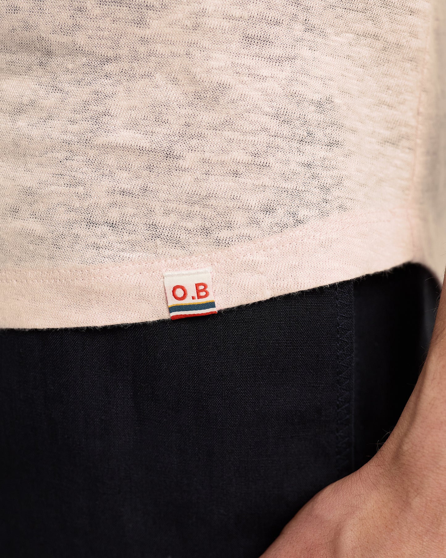 Close-up of a label on a garment with 'O.B.' branding.