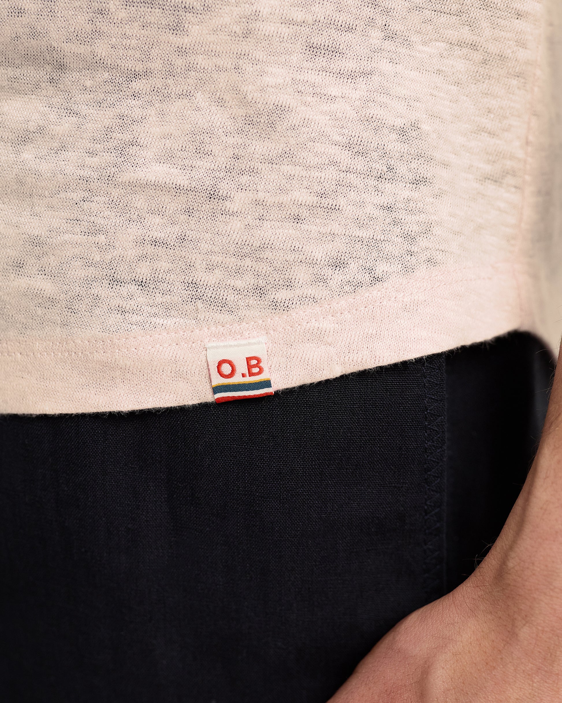 Close-up of a label on a garment with 'O.B.' branding.