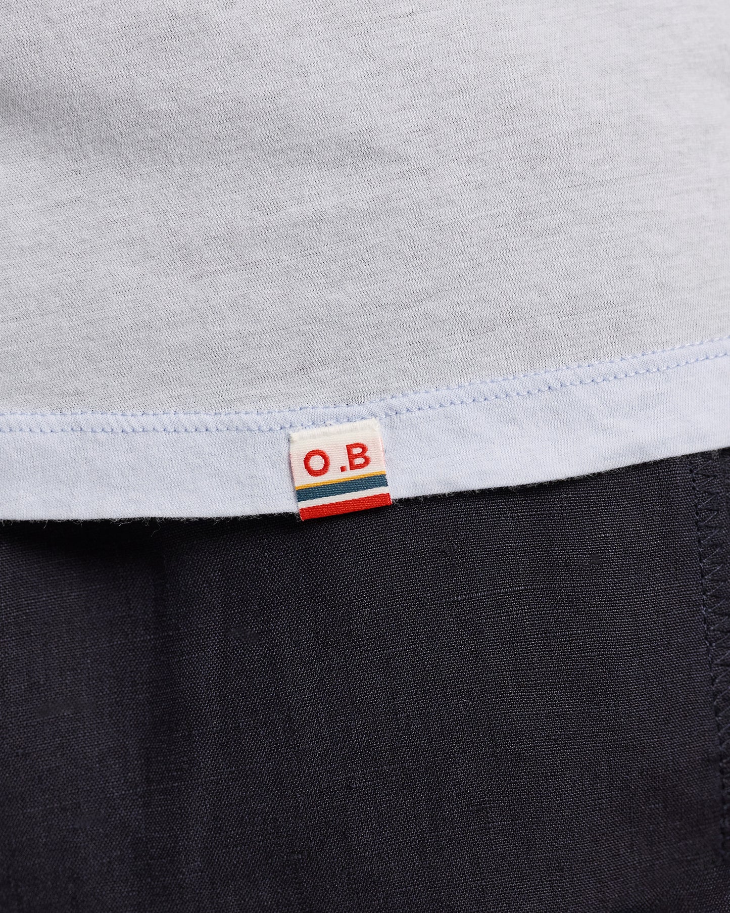 Close-up of a label on a garment with 'O.B.' branding.