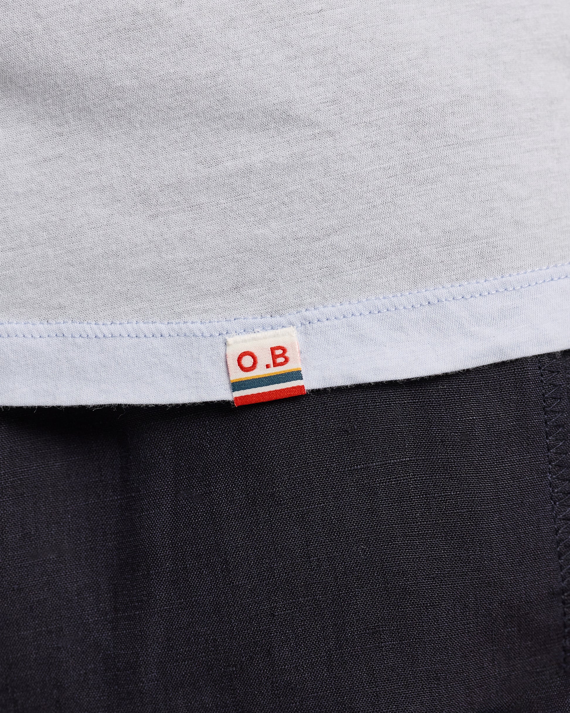 Close-up of a label on a garment with 'O.B.' branding.