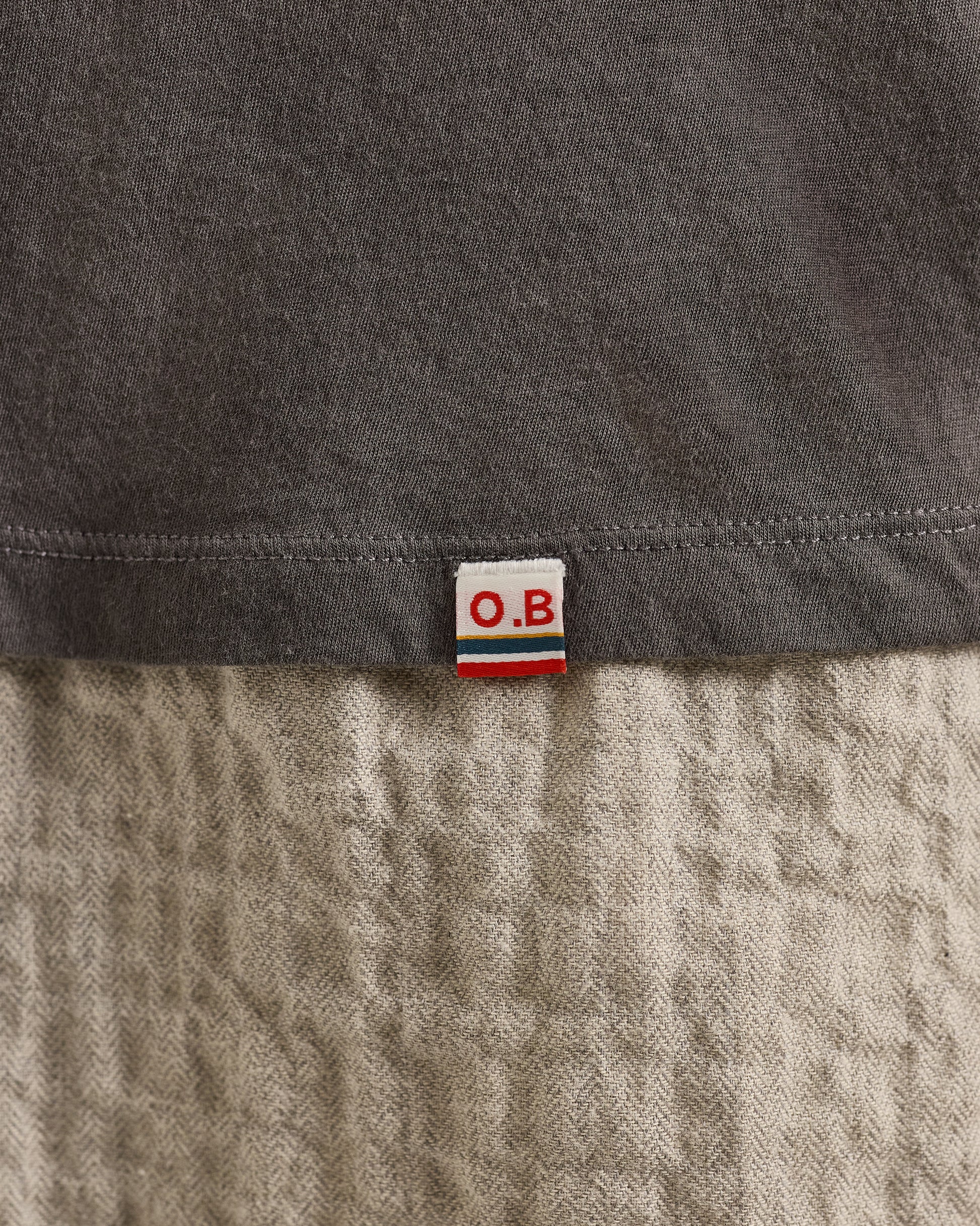 Close-up of a label on a piece of fabric with 'O.B.' branding.