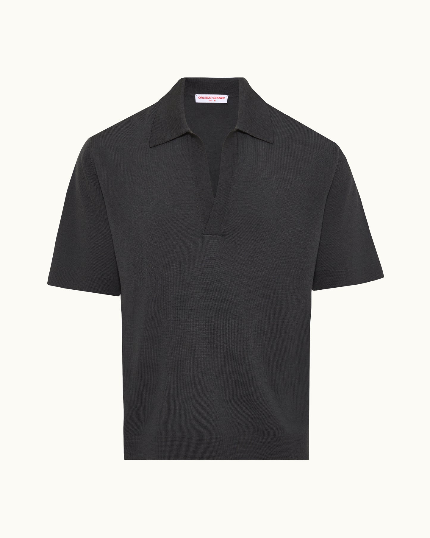A black short-sleeve polo shirt with a classic collar and a partial button placket, shown against a plain off-white background.