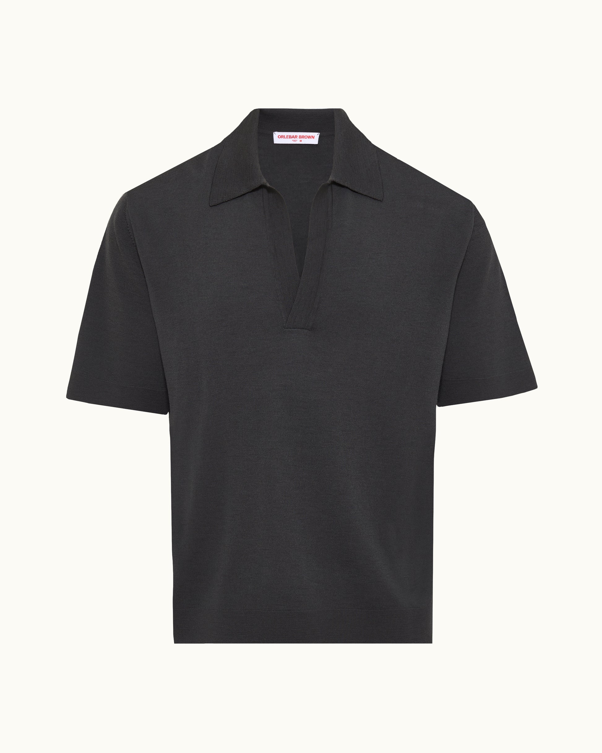 A black short-sleeve polo shirt with a classic collar and a partial button placket, shown against a plain off-white background.