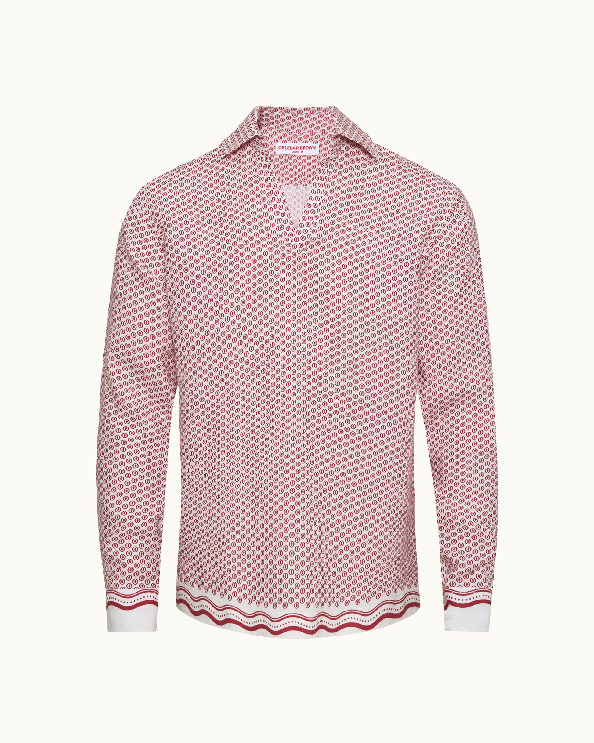 A long-sleeve button-up shirt with a pink and white geometric pattern, featuring a V-neckline, pointed collar, and a wavy striped border at the hem and cuffs.