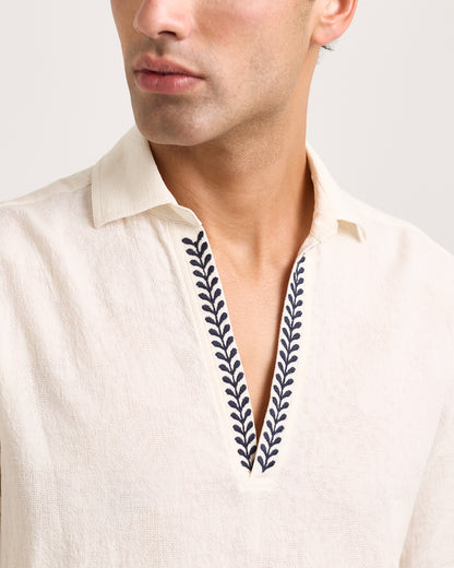 Close-up of White shirt with embroidered design on a white background