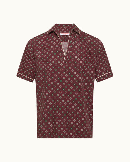 Maroon patterned polo shirt on a white background