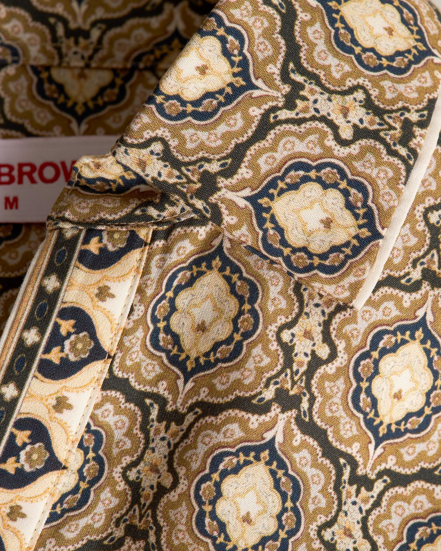 Close-up of patterned fabric with a label indicating 'Brown'.