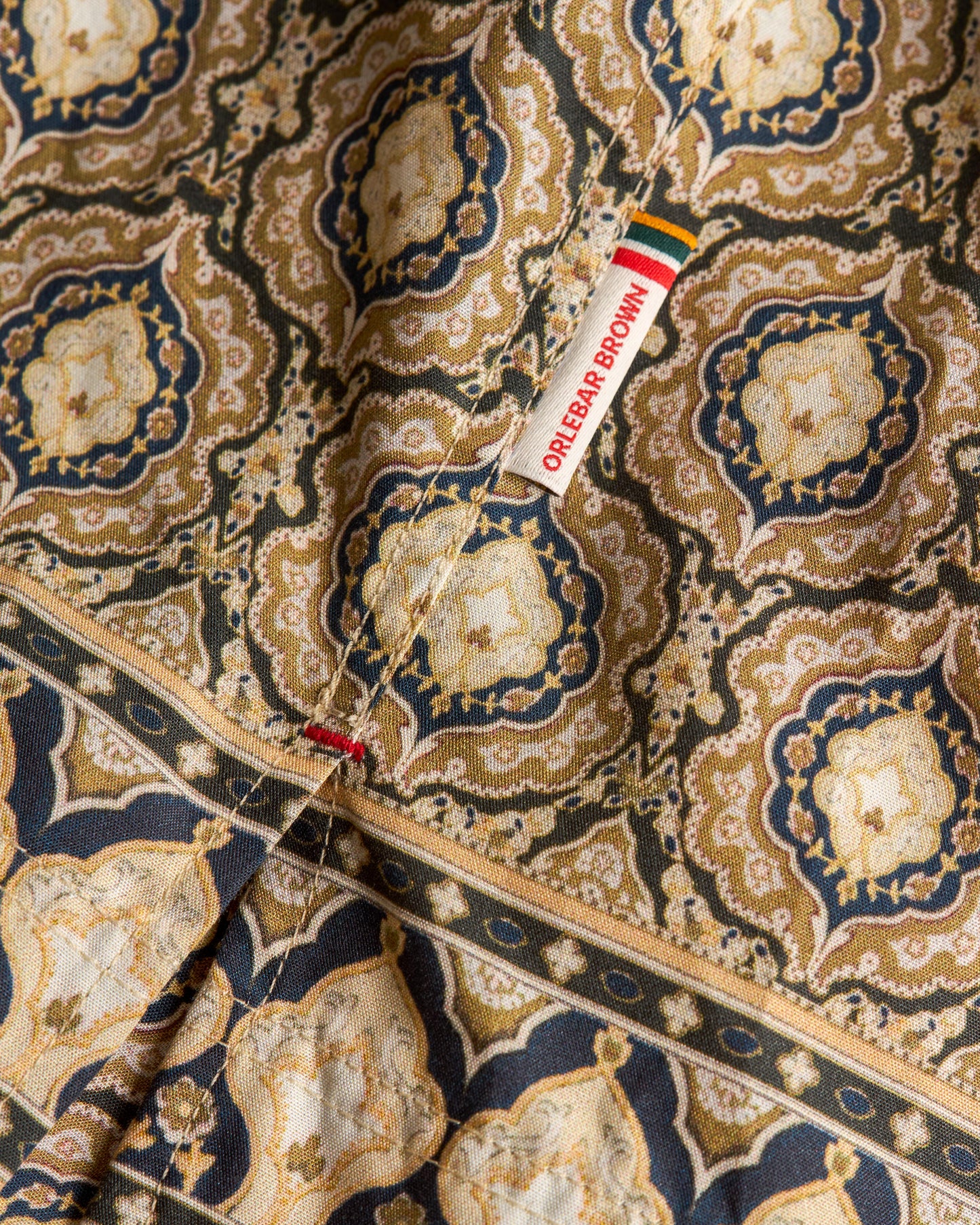 Close-up of a patterned fabric with a color swatch label.