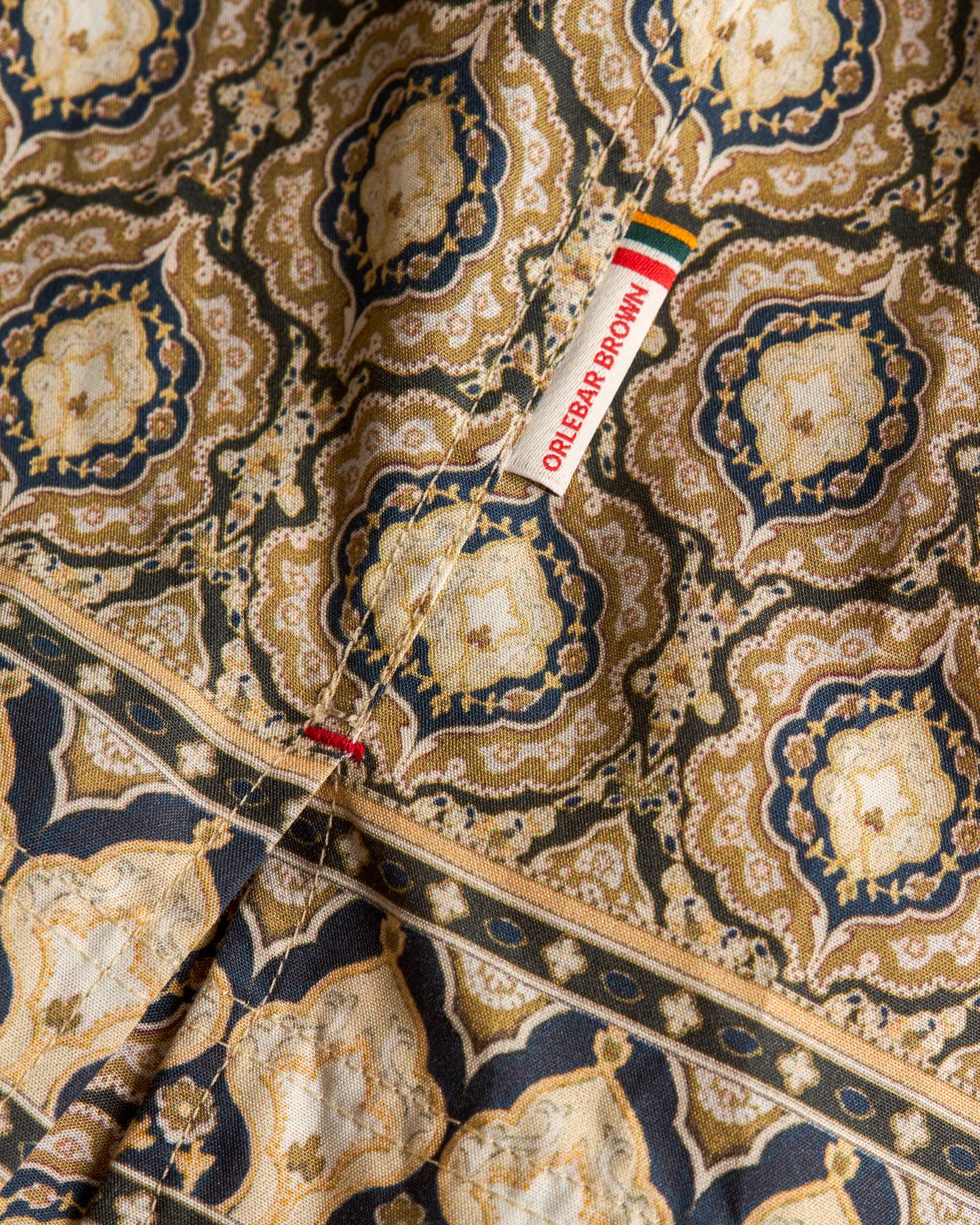 Close-up of a patterned fabric with a color swatch label.