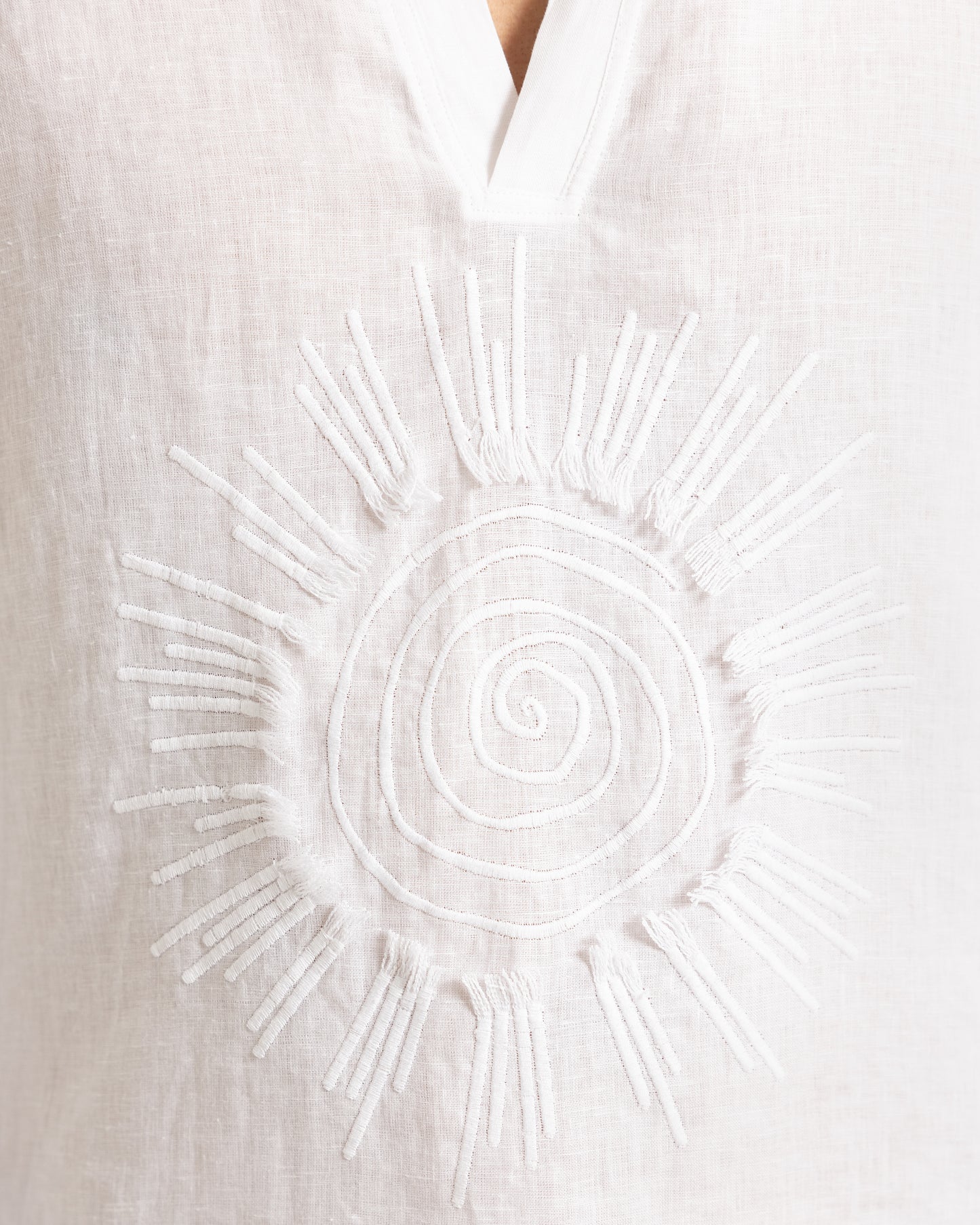 Closeup of sunshine embroidery on a white shirt