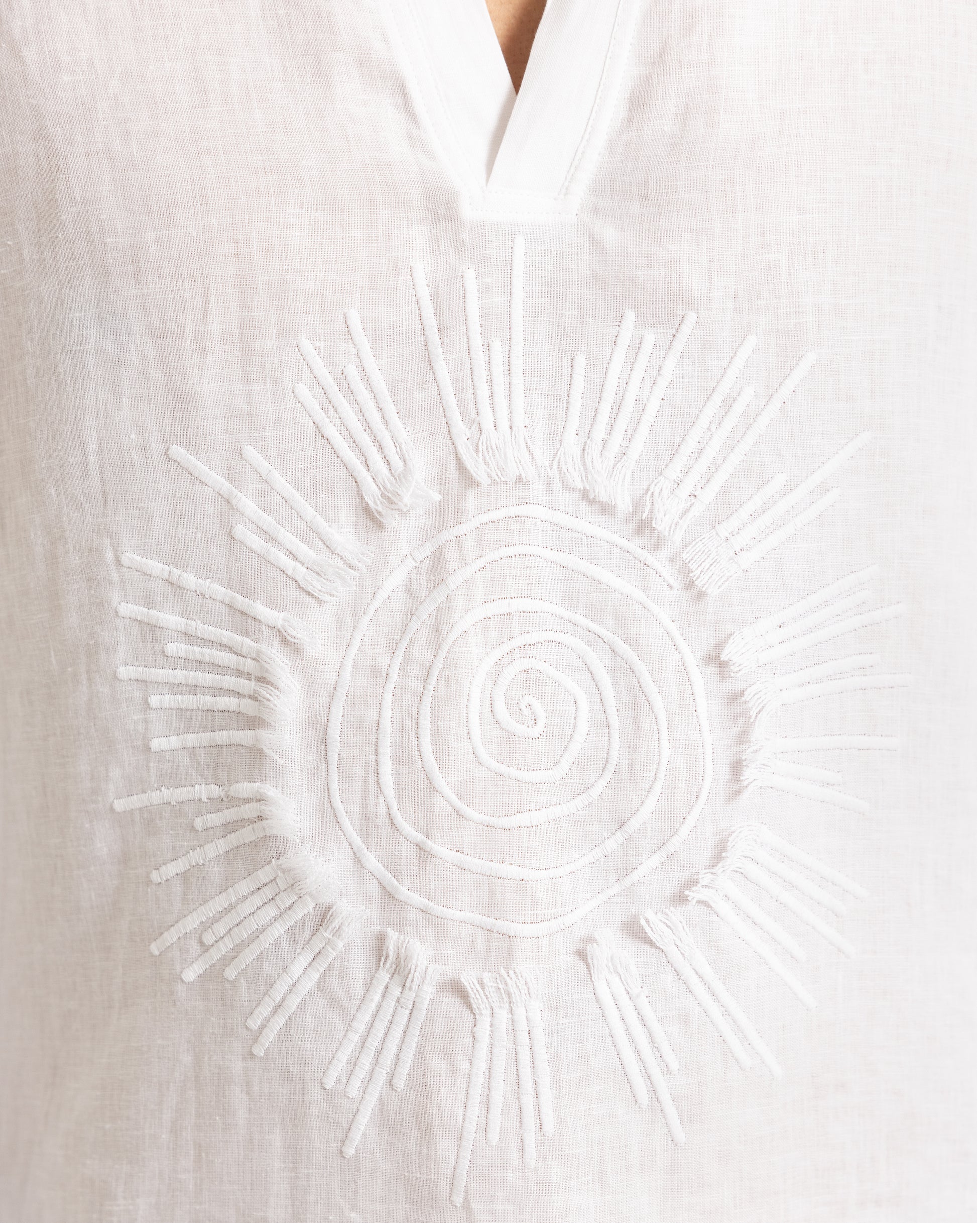 Closeup of sunshine embroidery on a white shirt