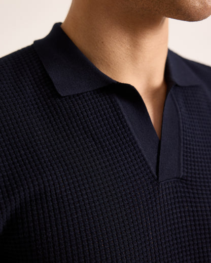 Navy blue textured polo shirt worn by a person