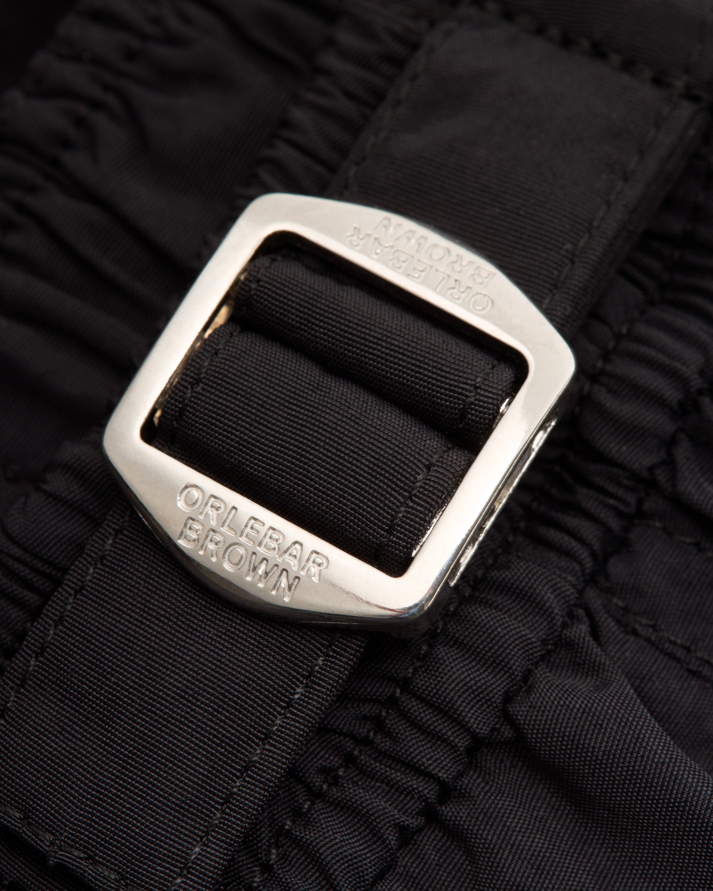 Closeup of of silver buckle on black background