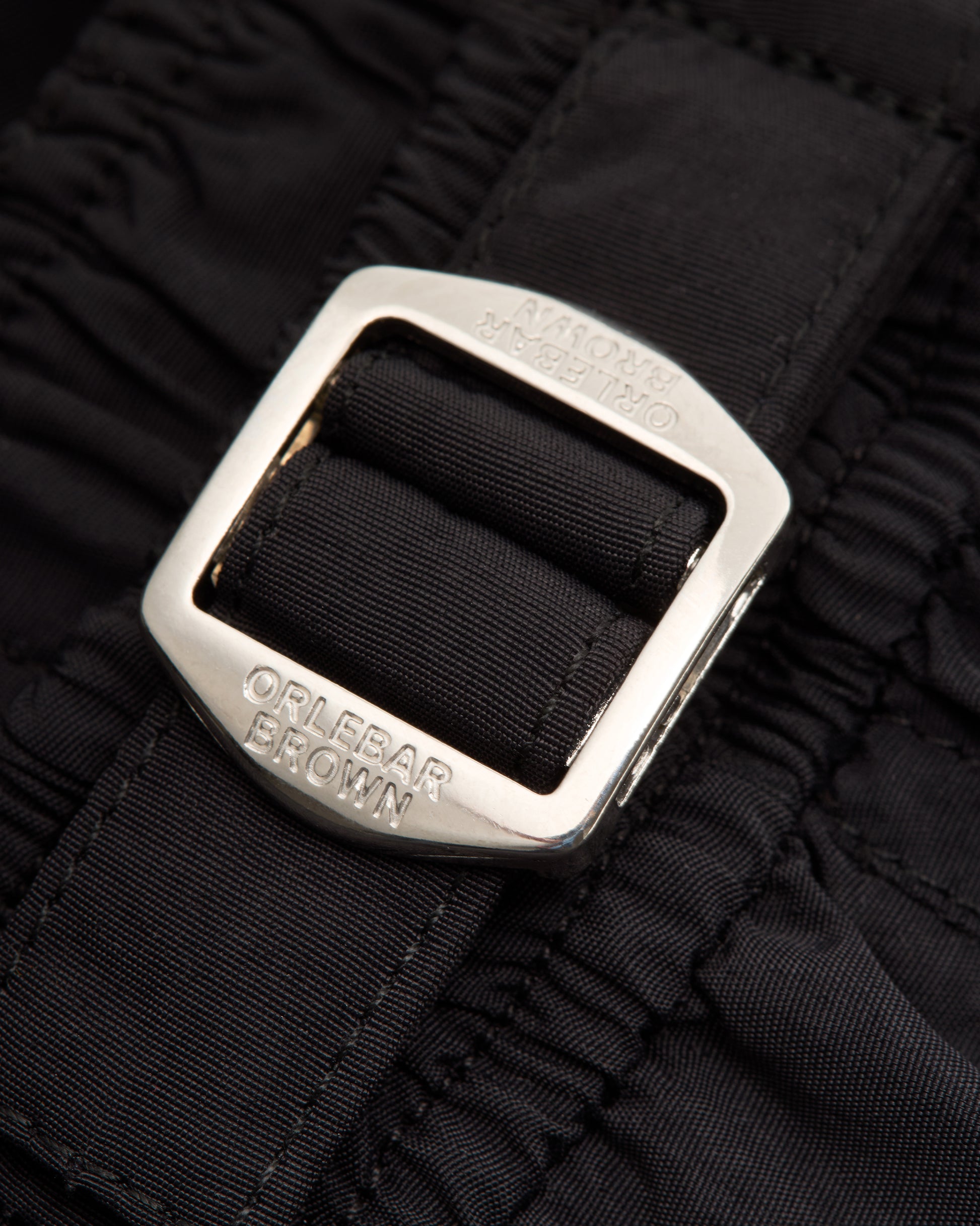 Closeup of of silver buckle on black background