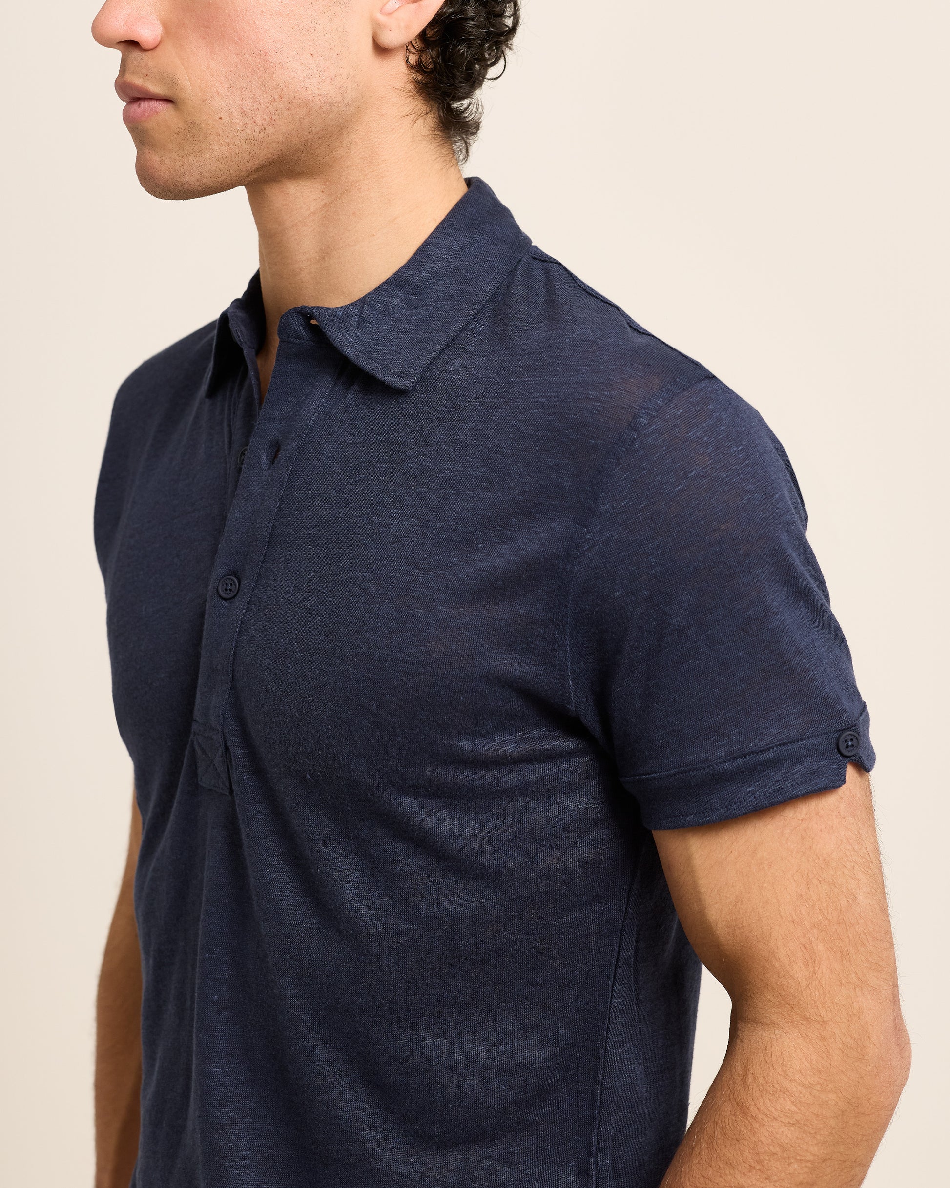 Closeup of man wearing dark navy polo shirt 