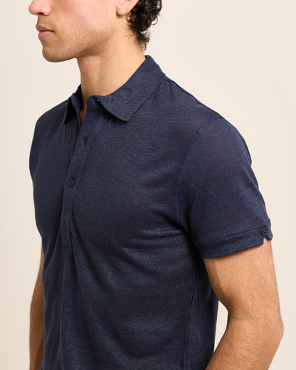 Closeup of man wearing dark navy polo shirt 