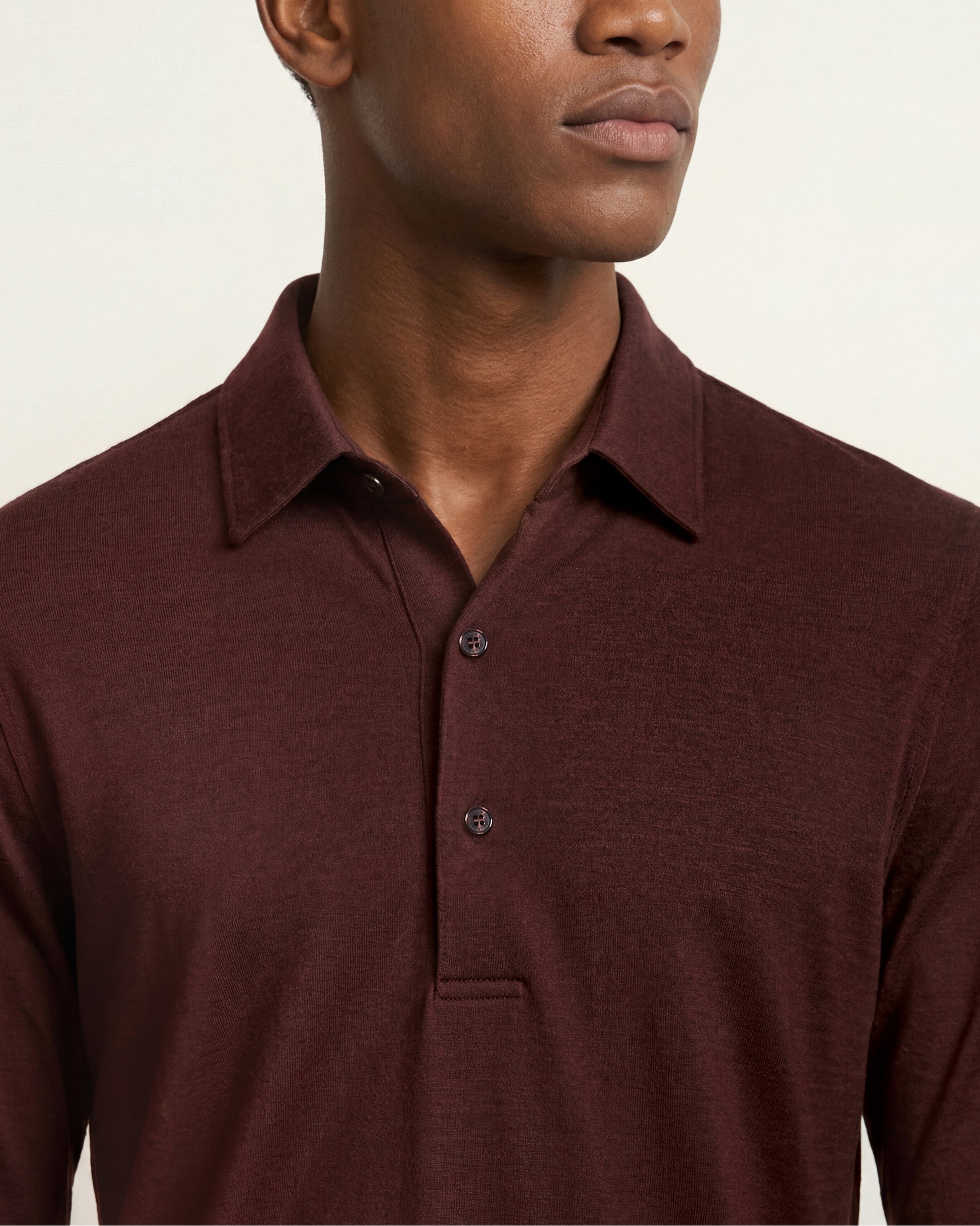 Close up of the collar and button up section of the merino long sleeve polo