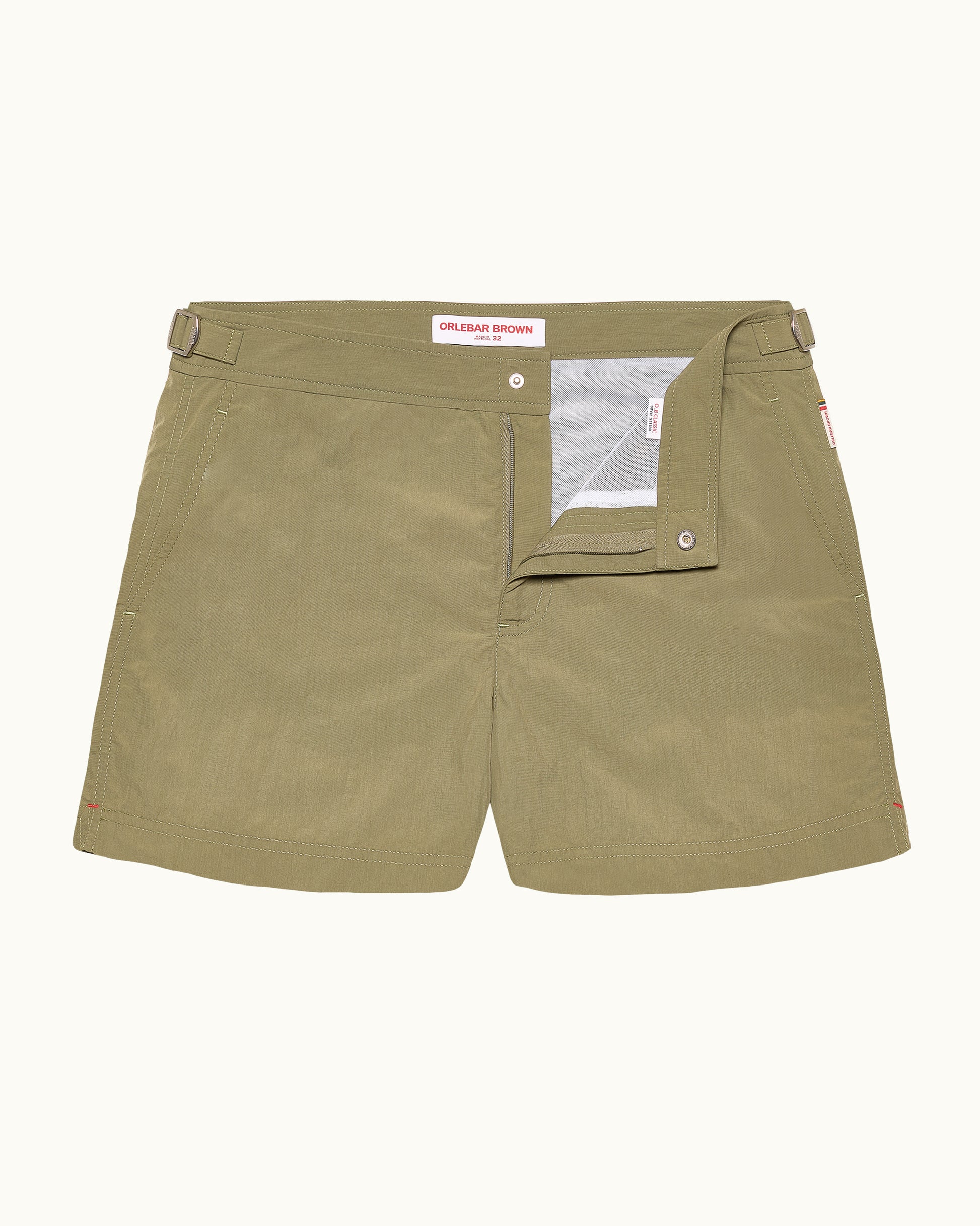 Olive green shorts with a brand label on a white background