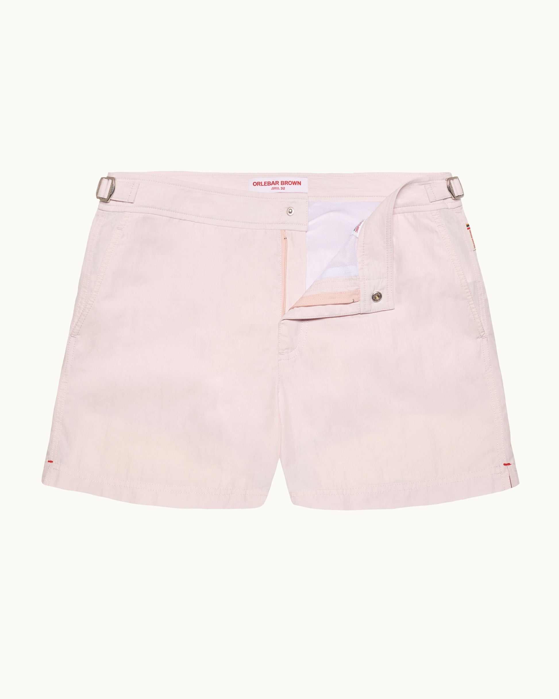 Light pink shorts with a brand logo on a white background