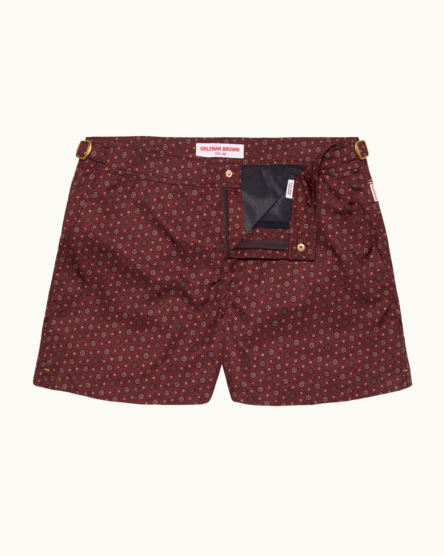 Maroon patterned shorts with gold buttons on a white background