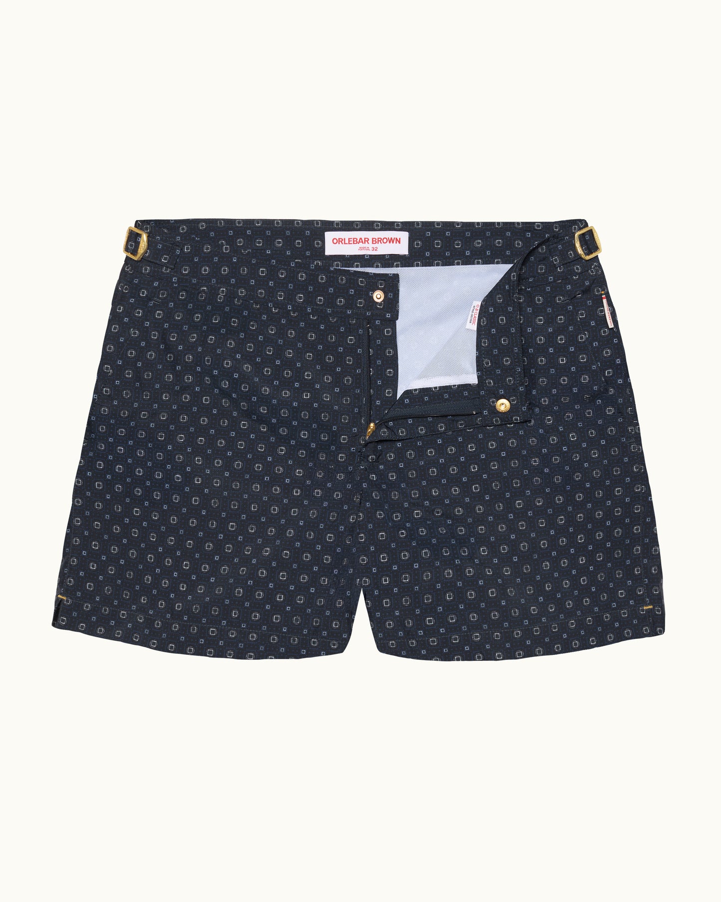 Navy patterned shorts with gold details on a white background