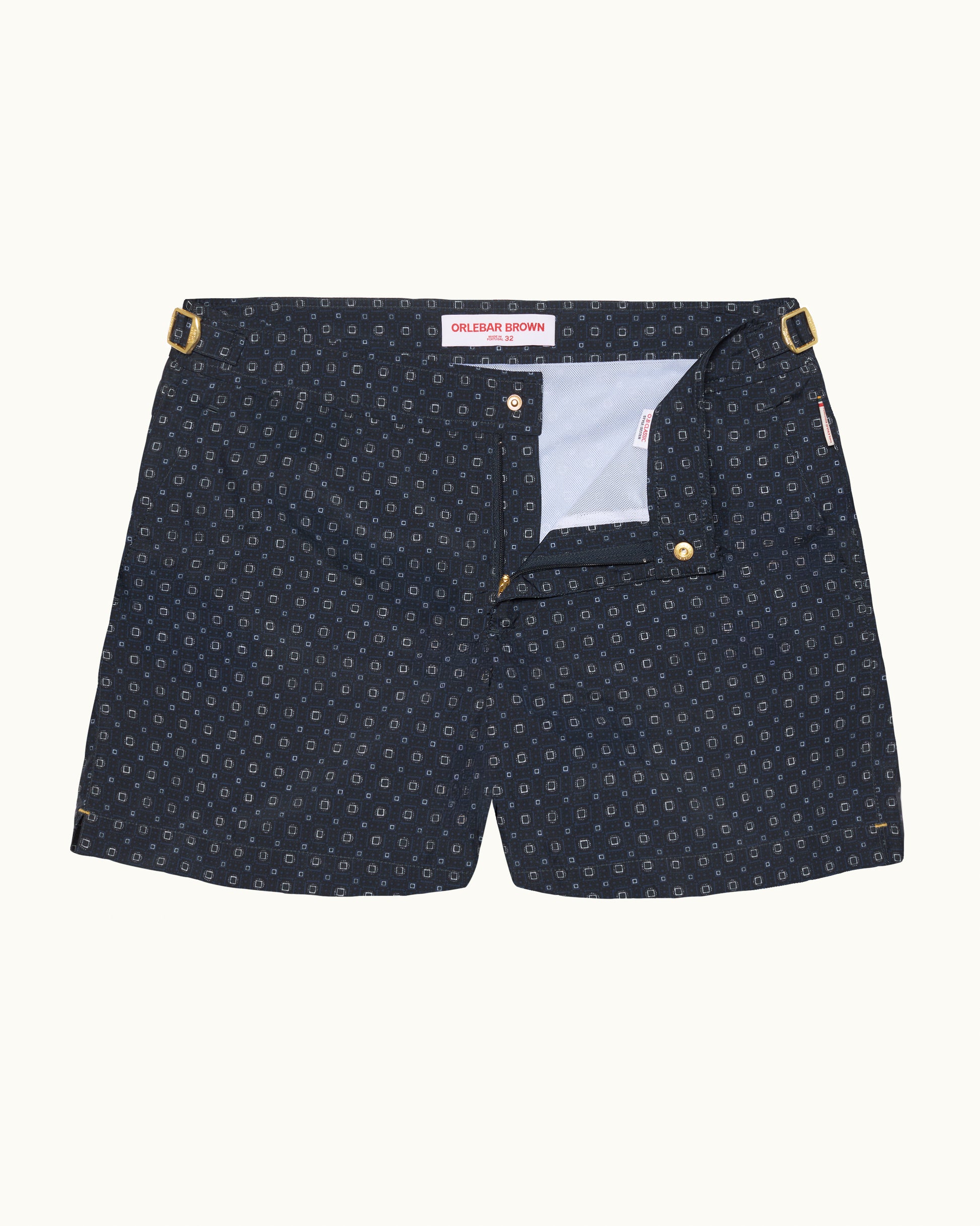 Navy patterned shorts with gold details on a white background