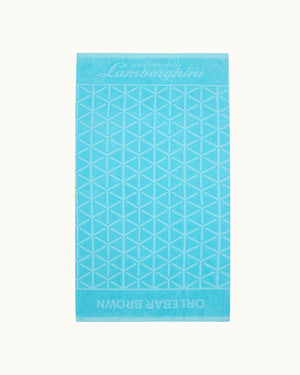 Blue towel with geometric pattern and Lamborghini branding on a white background