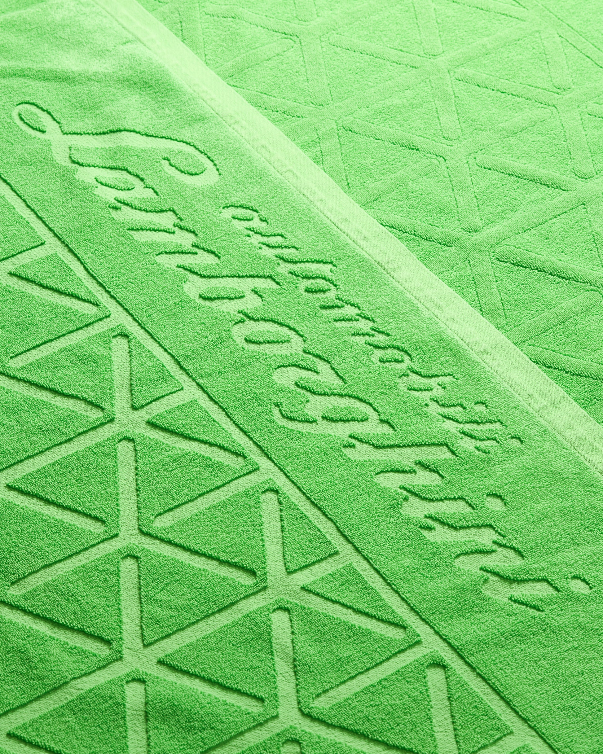 Close-up of a green textured surface with embossed text