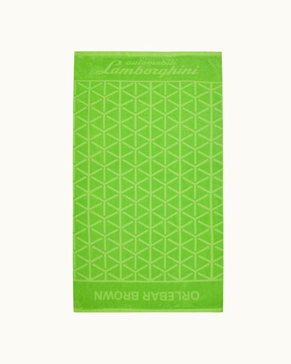 Green towel with geometric pattern and Lamborghini branding on a white background