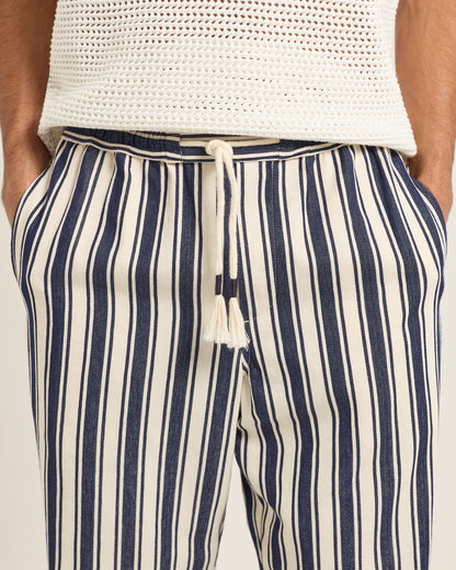 Navy and white striped pants with a drawstring on a neutral background
