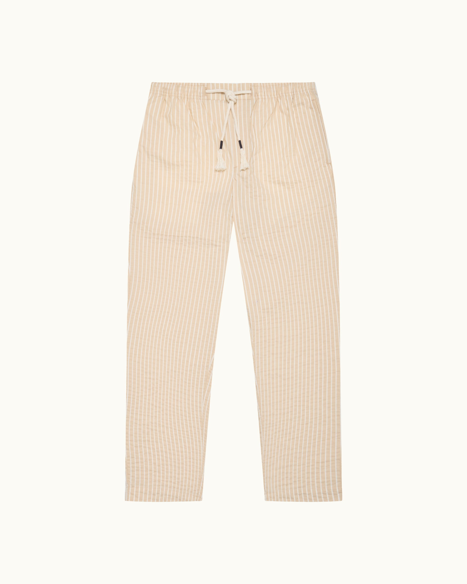 Light beige trousers with drawstring waist and subtle stripes on a light background