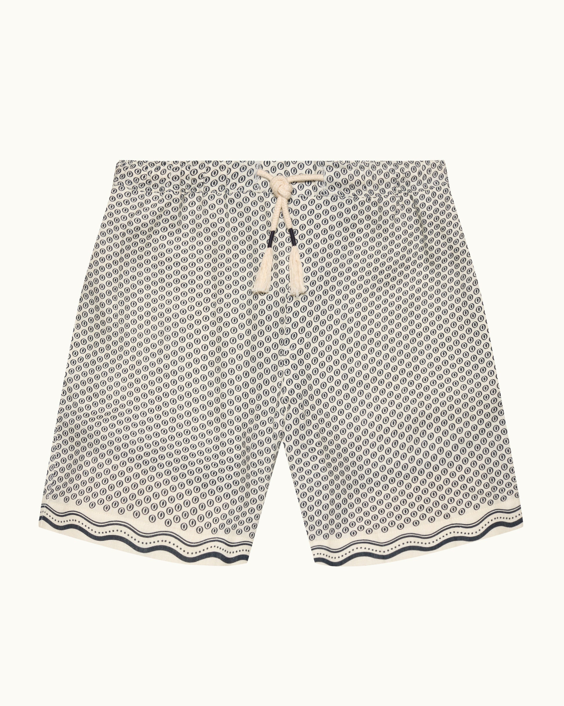 A pair of men's casual shorts featuring a black and white geometric honeycomb pattern, a cream-colored drawstring waist, and a wavy patterned hem, displayed flat against a light off-white background.