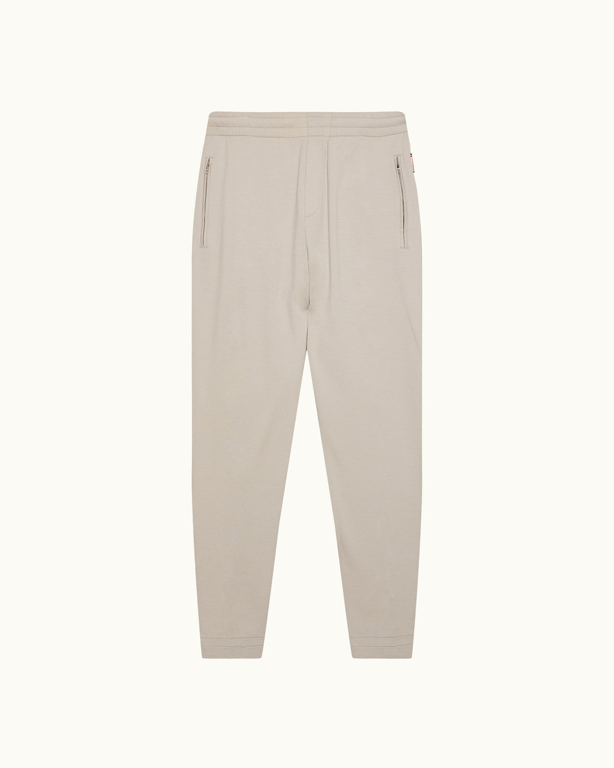 Light beige sweatpants on a plain background