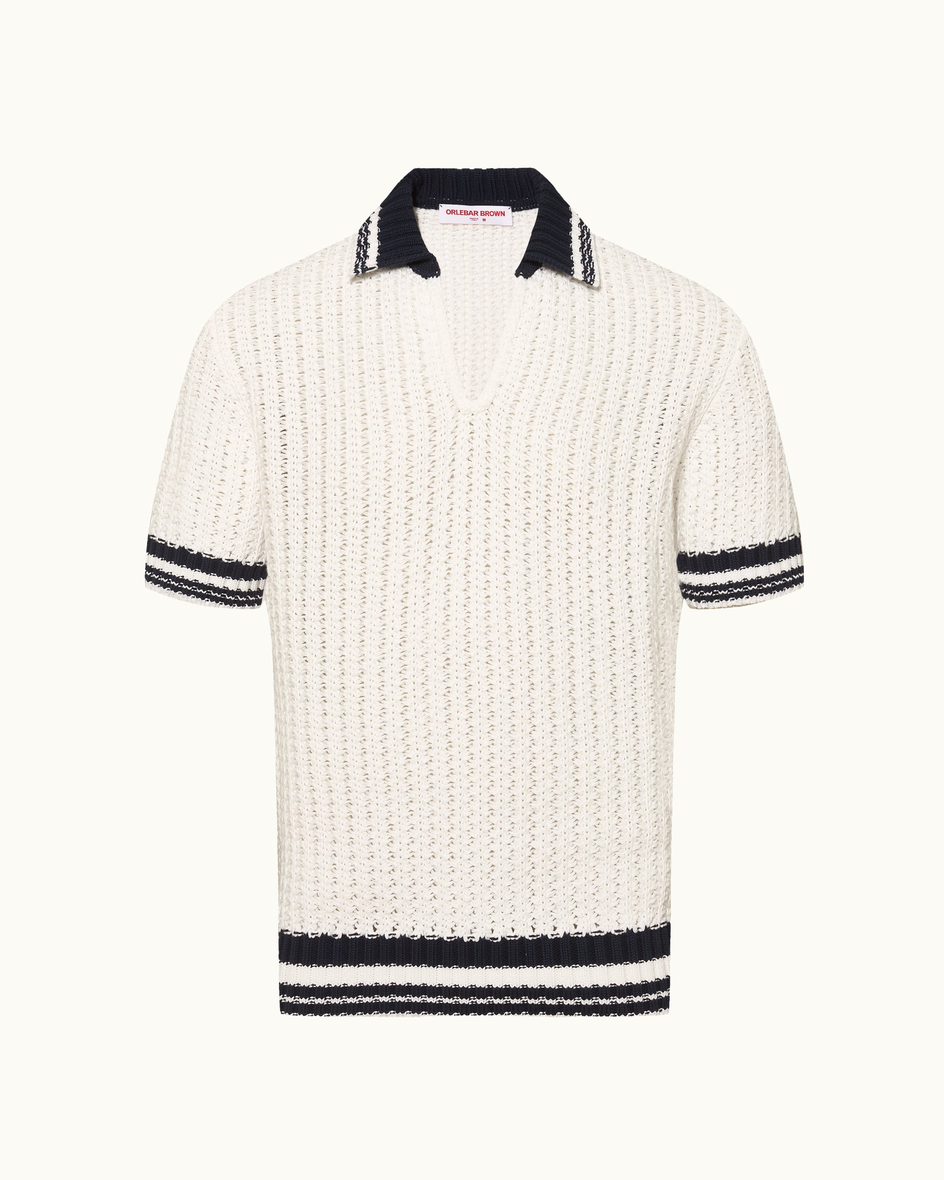 White knitted polo shirt with black trim on a white background