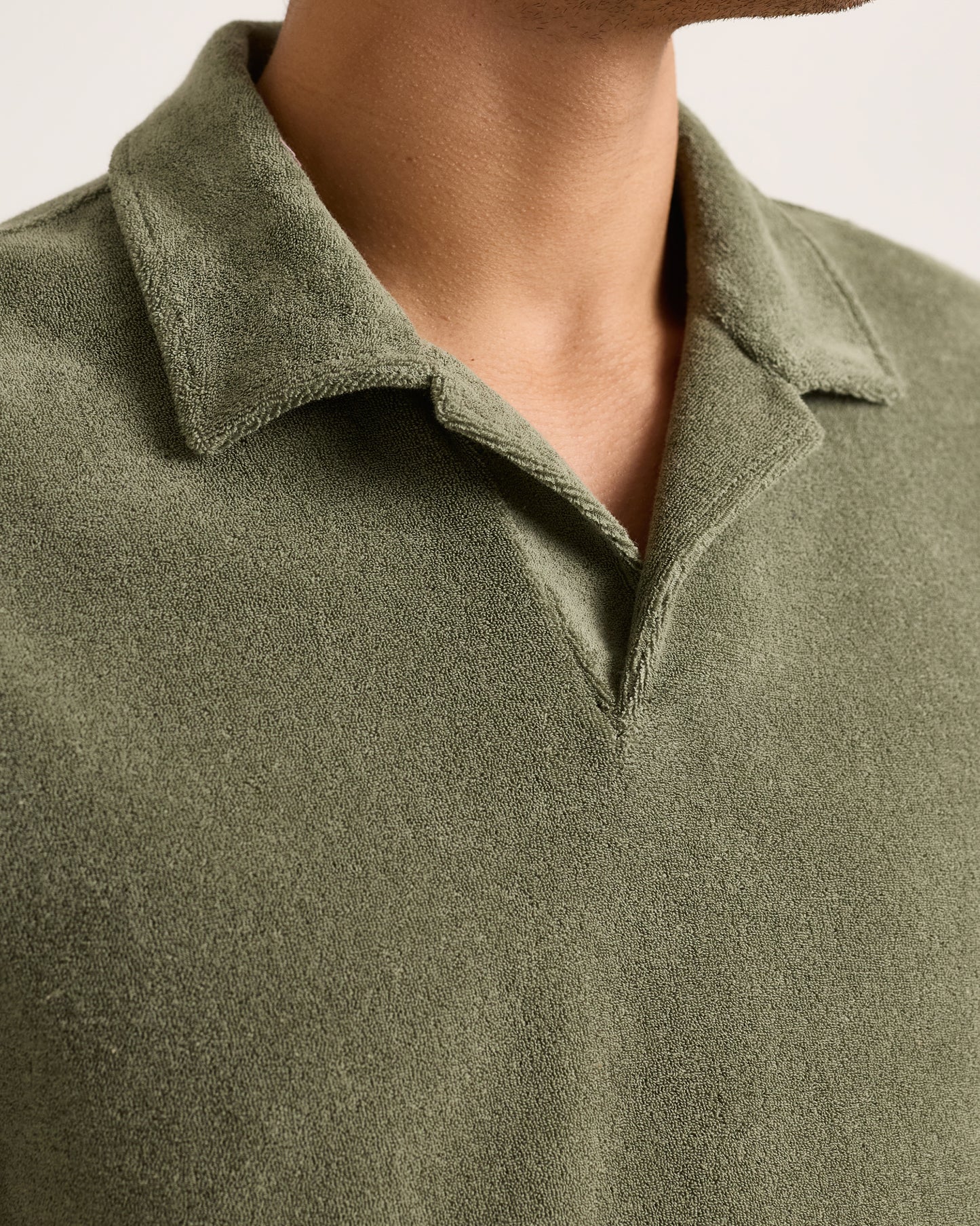 Close-up of a green polo shirt with a collar