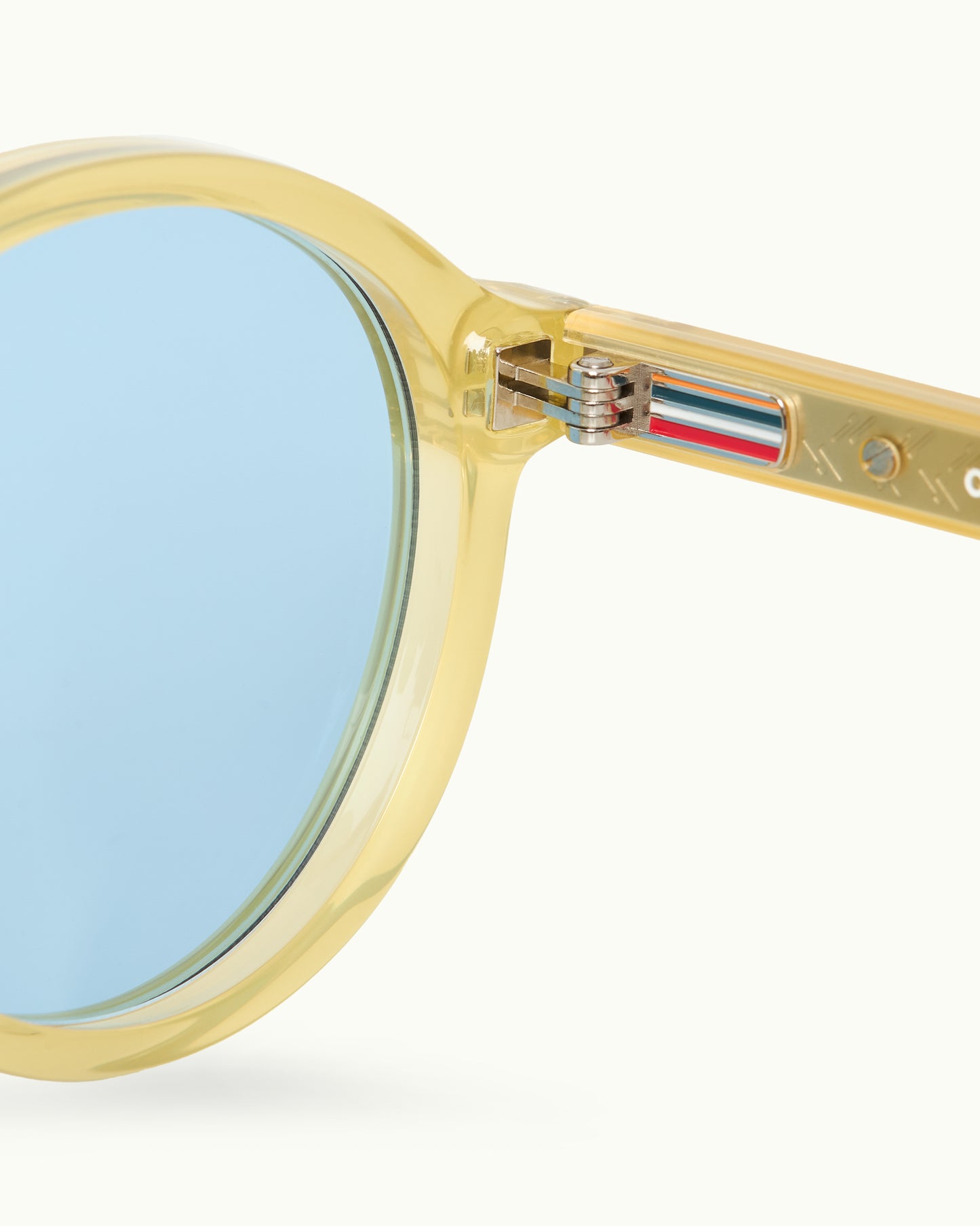 Sunglasses with gold frame and blue lenses on a white background