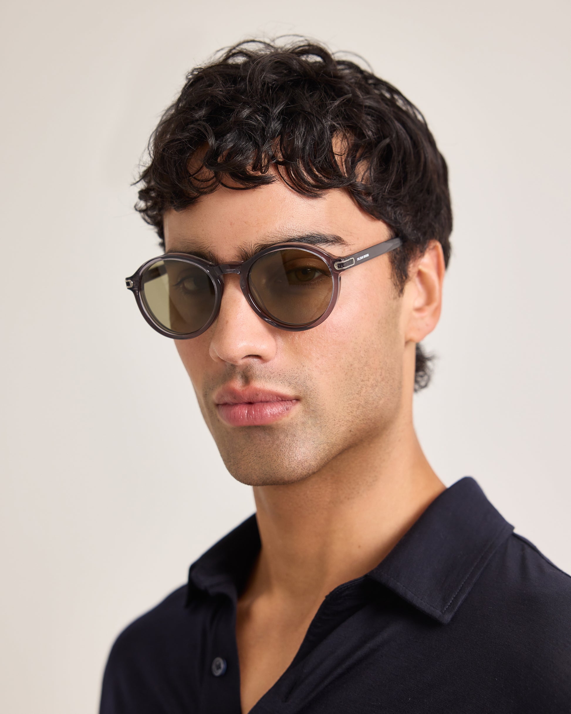 Man wearing sunglasses with a neutral background