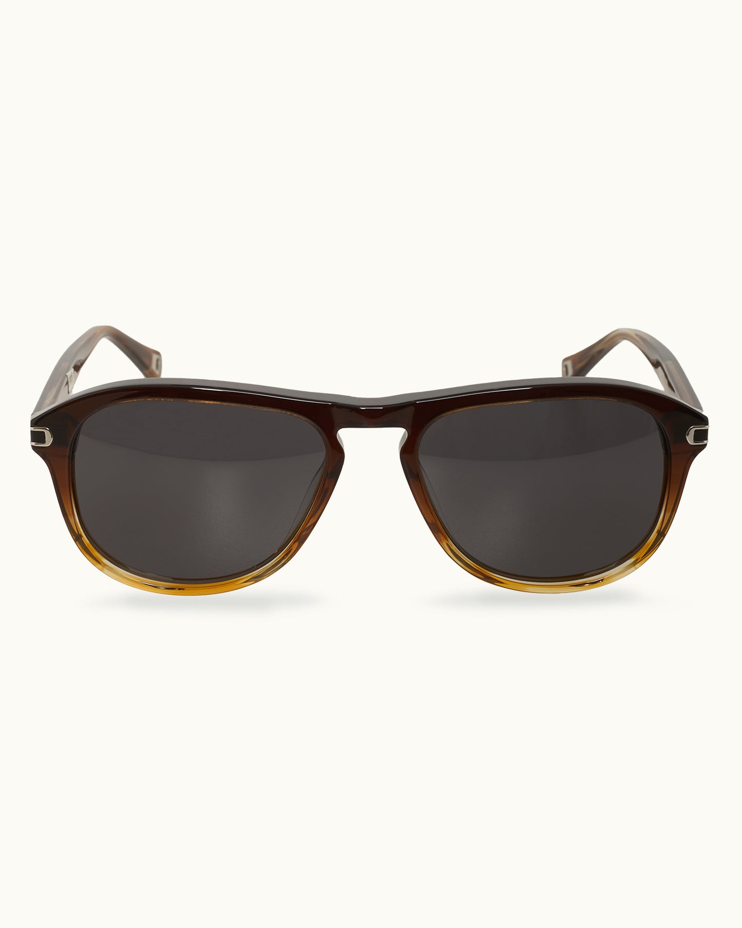 Sunglasses with brown frame and dark lenses on a white background