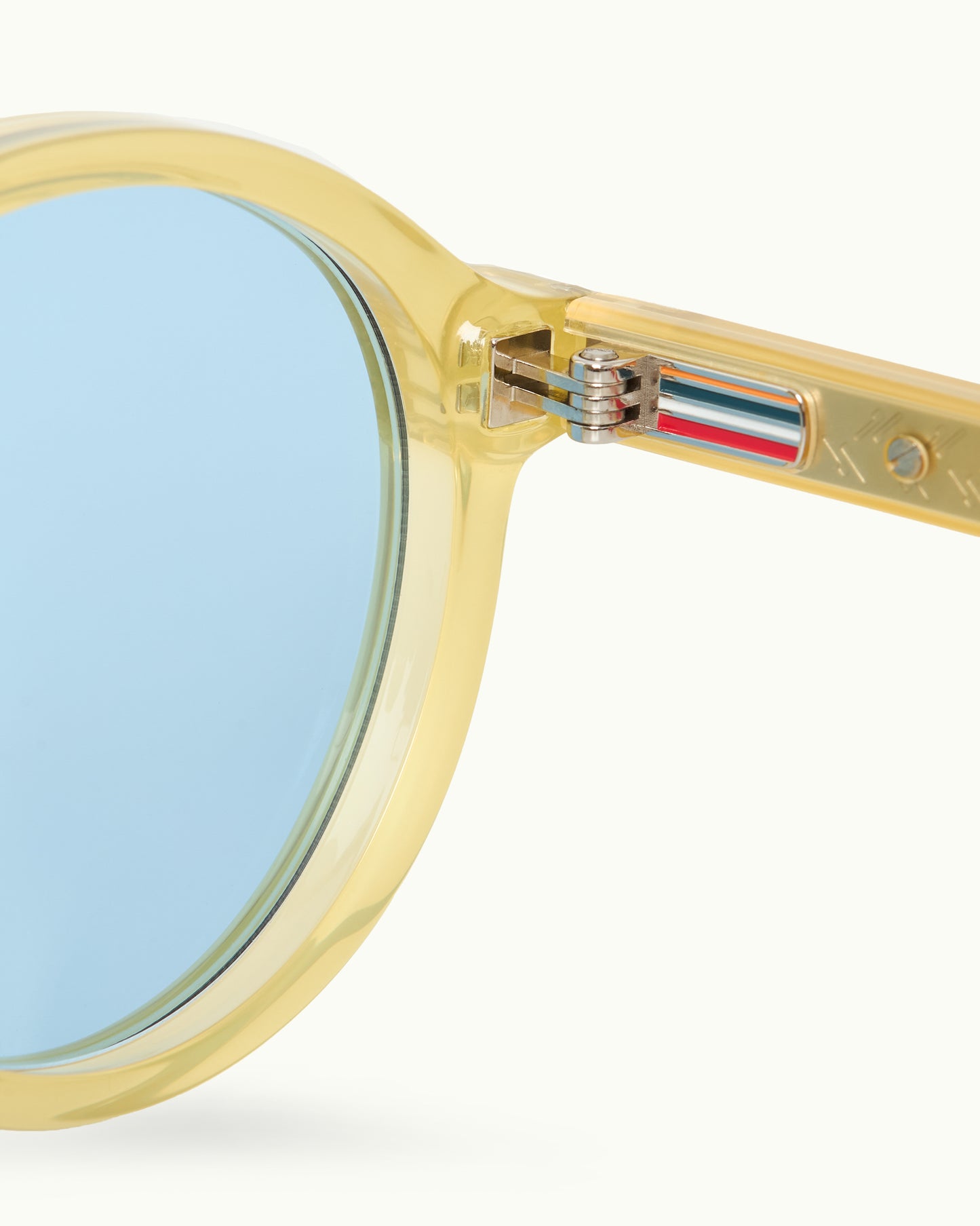Gold-framed sunglasses with blue lenses on a white background