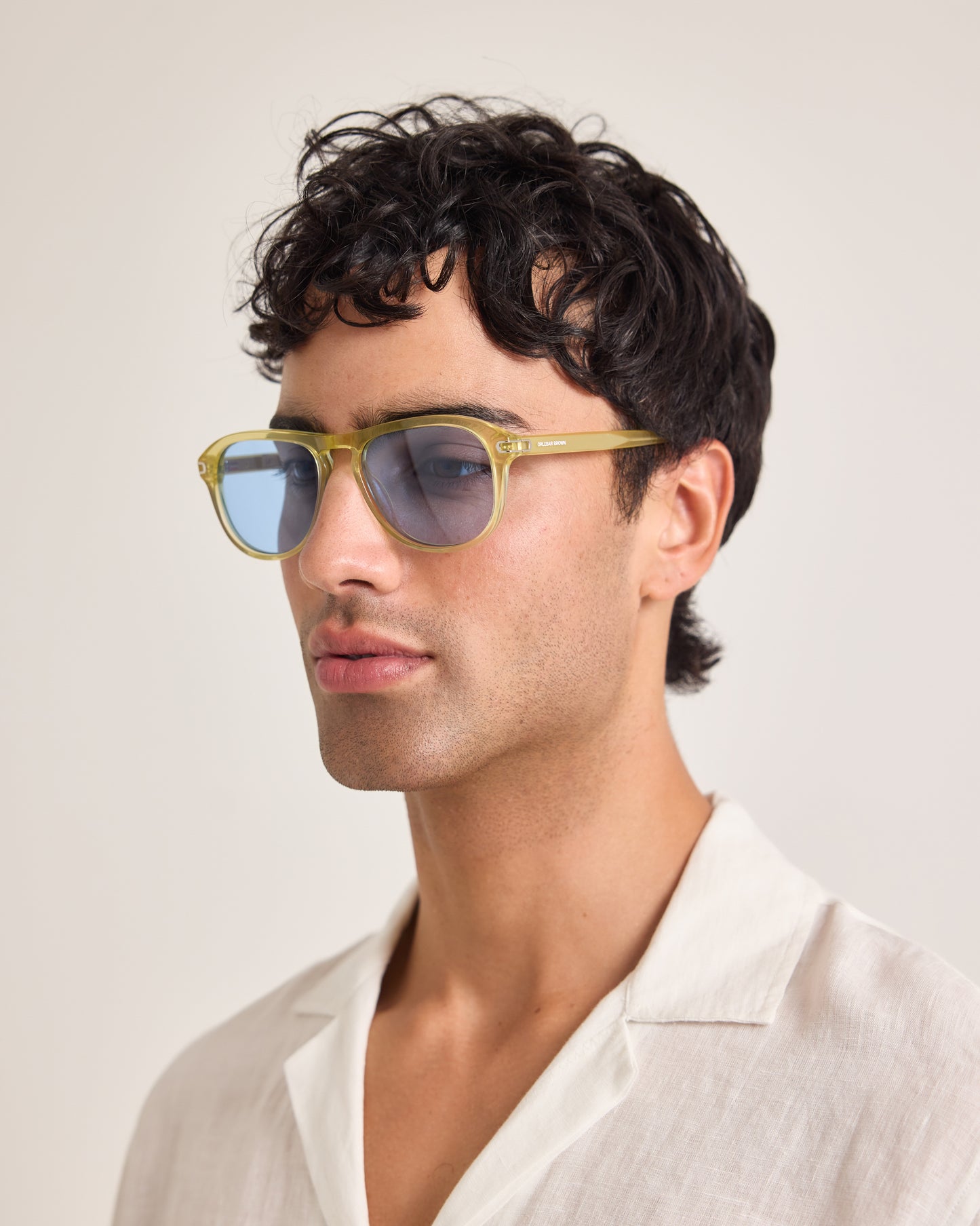 Man wearing sunglasses with a neutral background