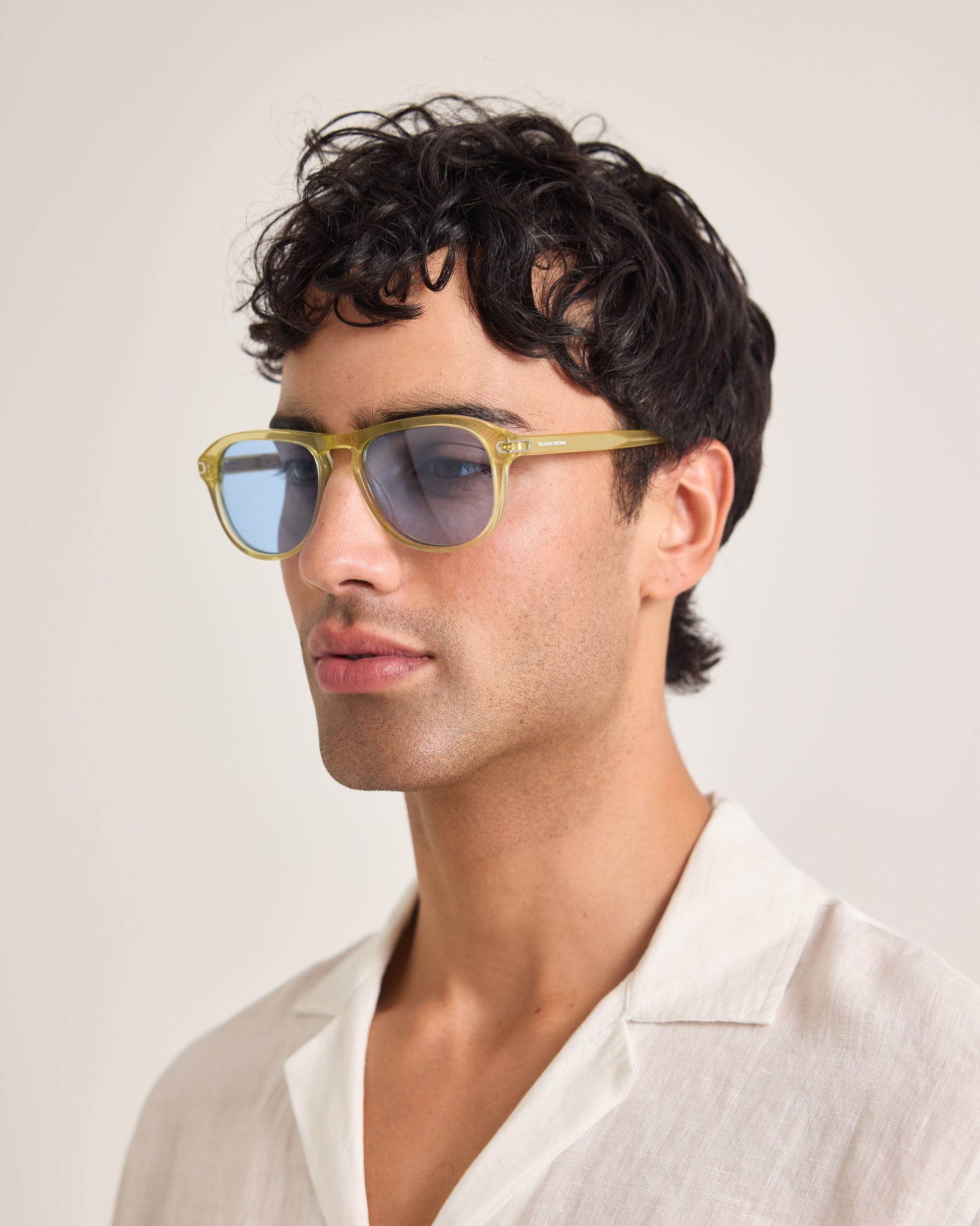 Man wearing sunglasses with a neutral background