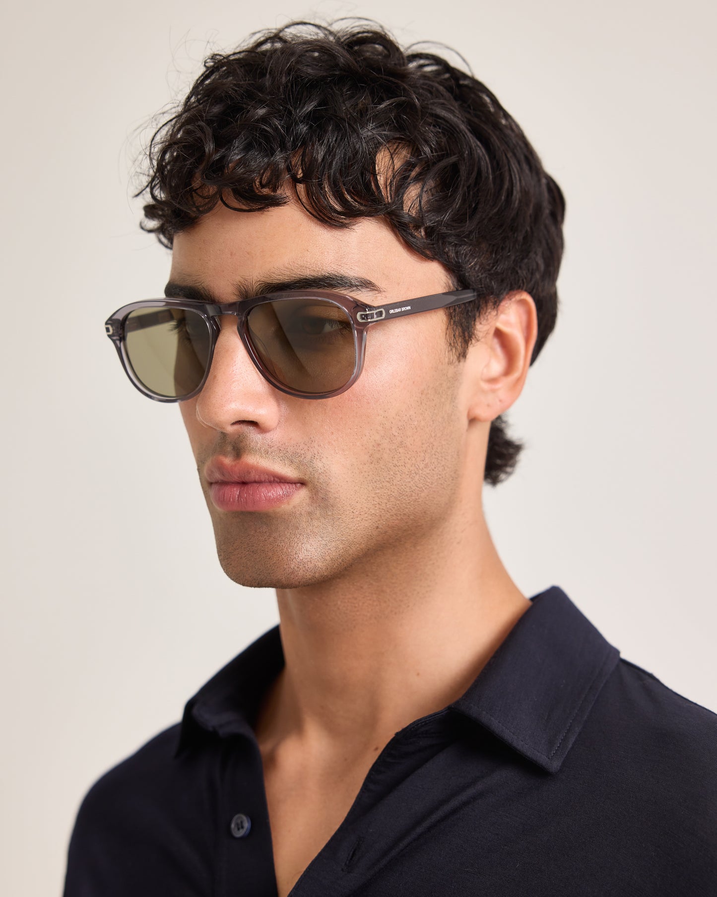 Man wearing sunglasses with a neutral background