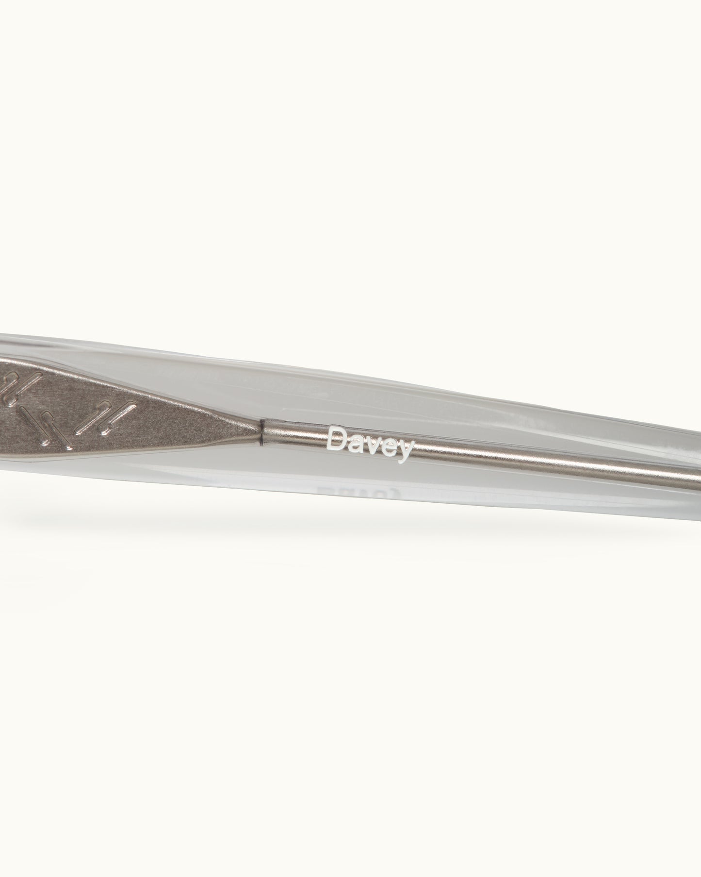 Close-up of a metal sunglasses with 'Davey' branding on a white background