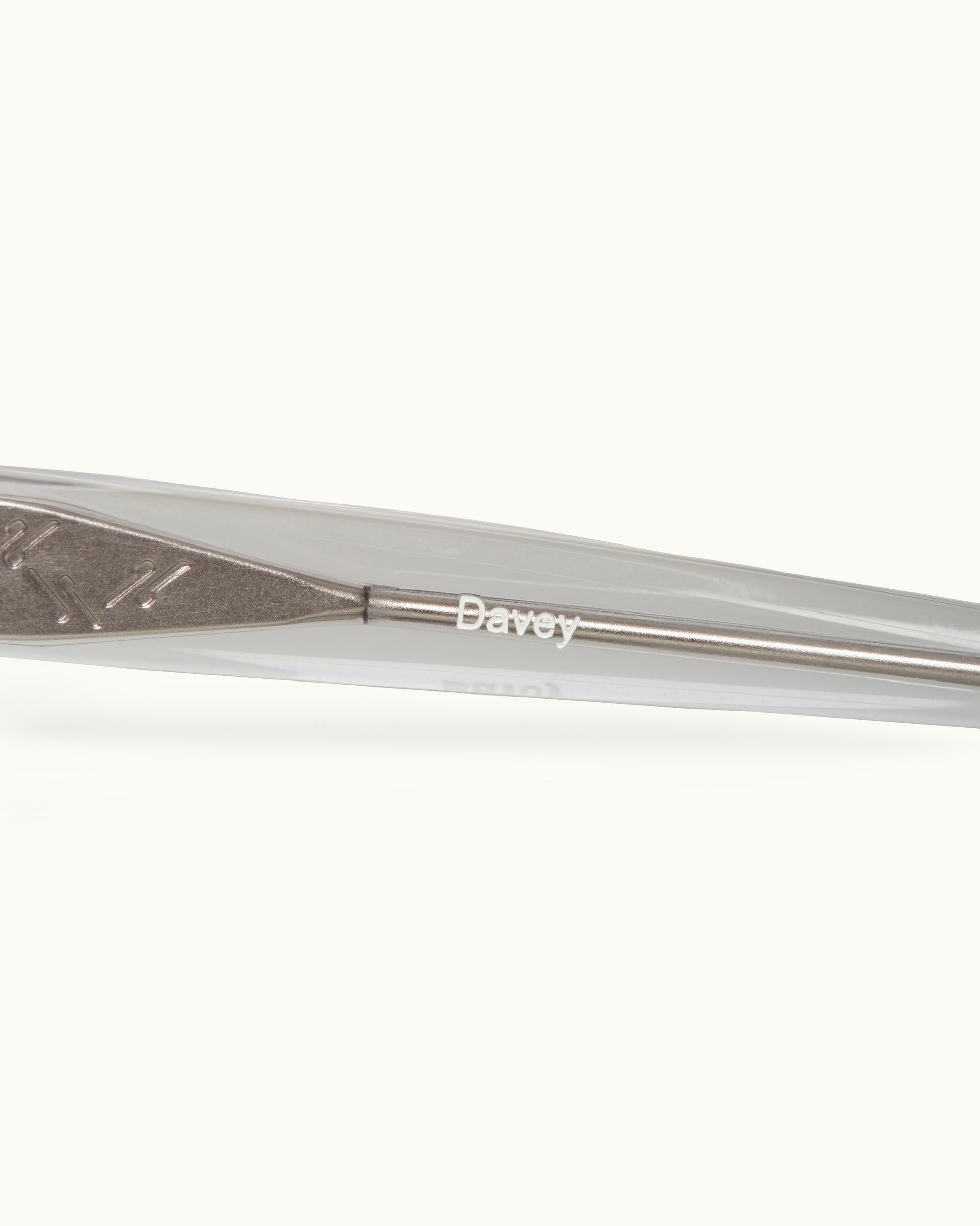 Close-up of a metal sunglasses with 'Davey' branding on a white background