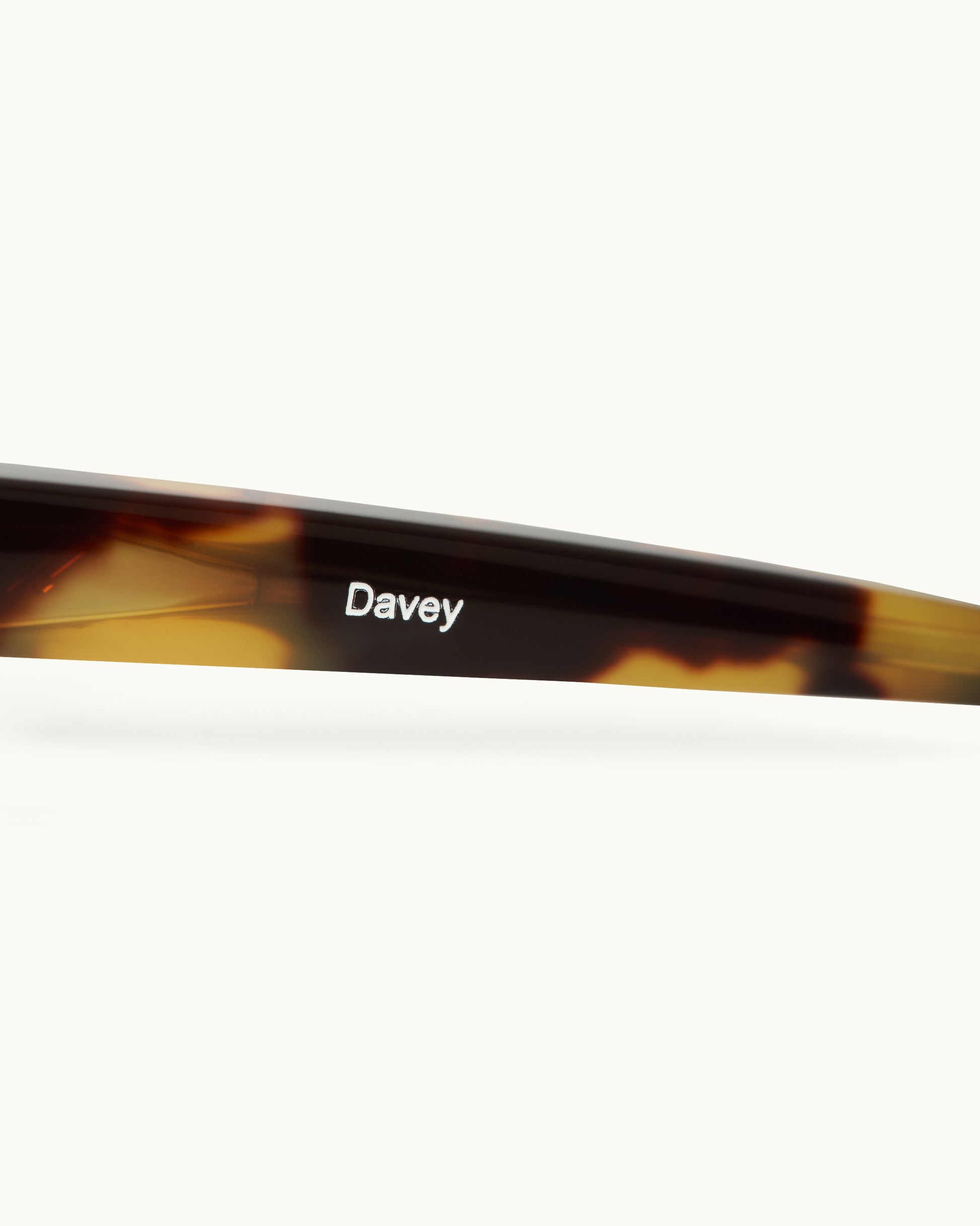 Tortoiseshell sunglasses with 'Davey' branding on a white background
