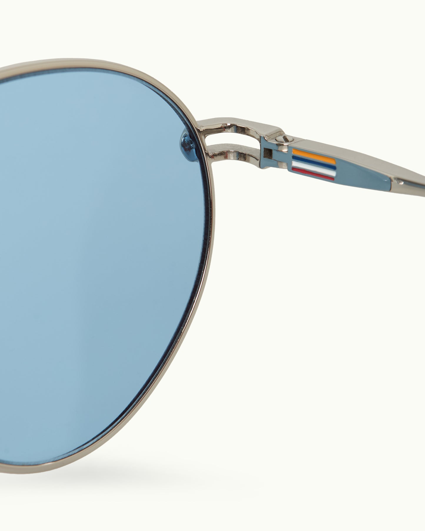 Sunglasses with blue lenses and a metallic frame on a white background