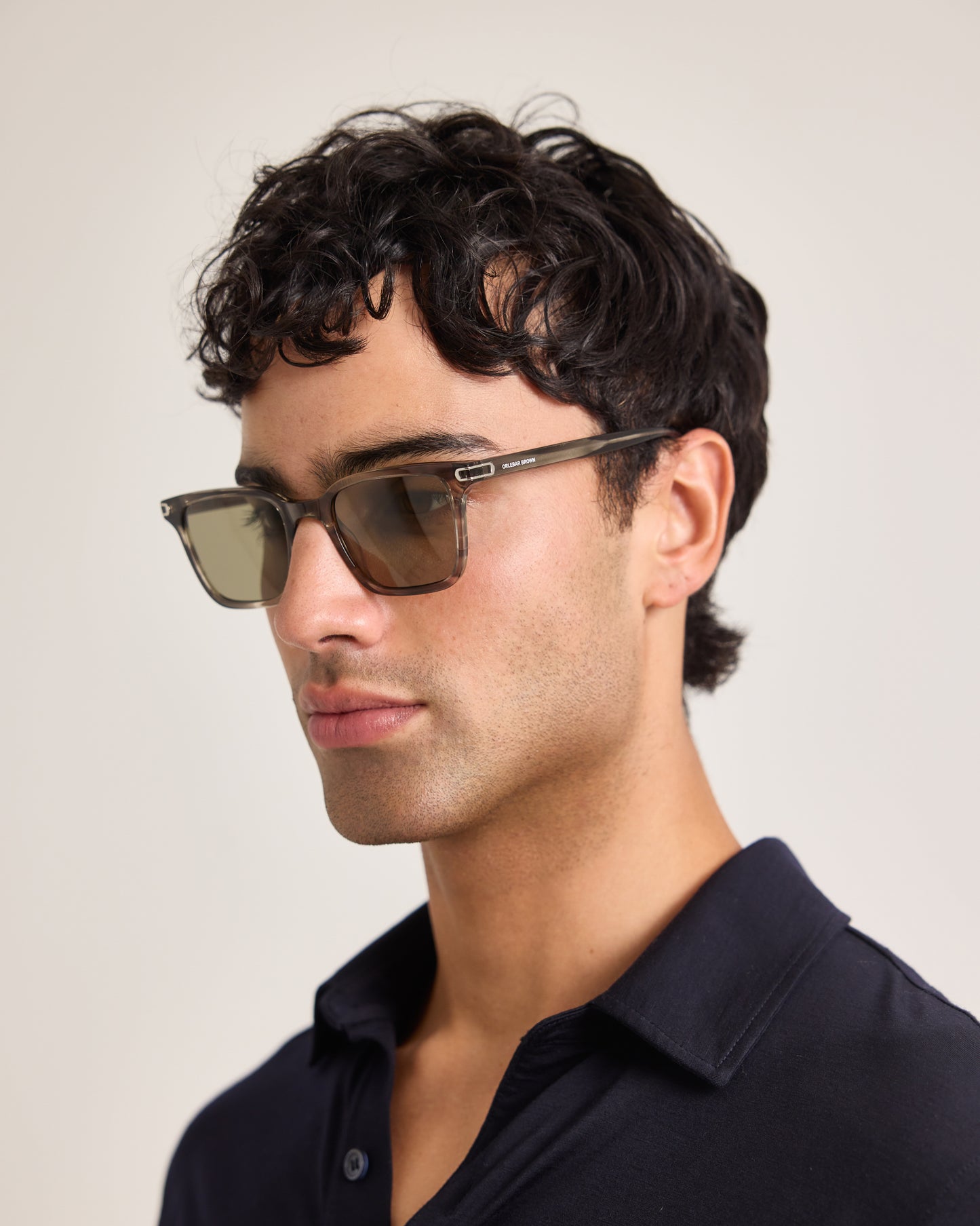 Man wearing sunglasses with a neutral background