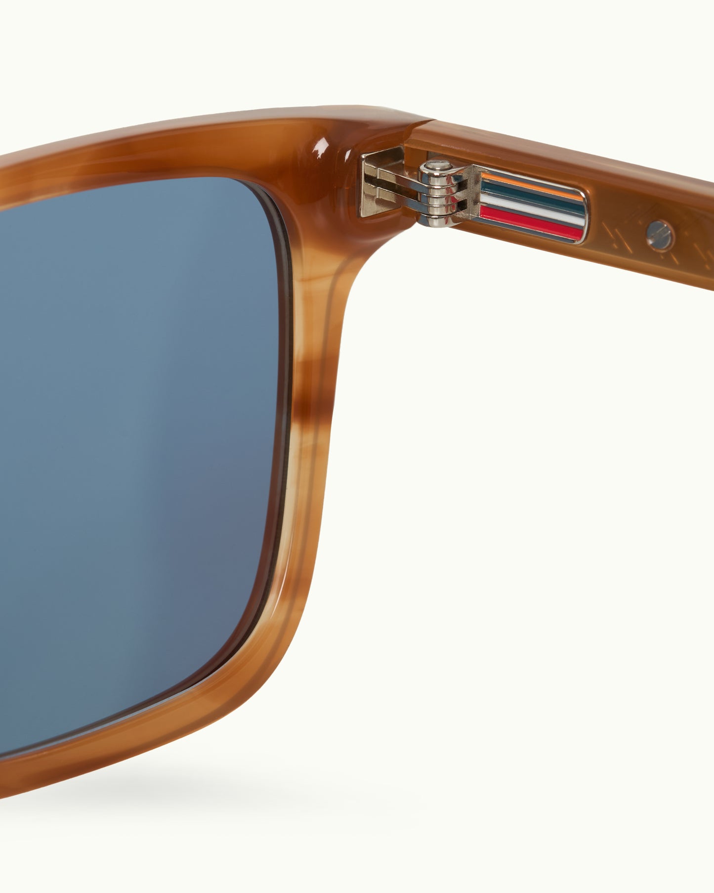 Close-up of a sunglasses with a brown frame and blue lenses on a white background