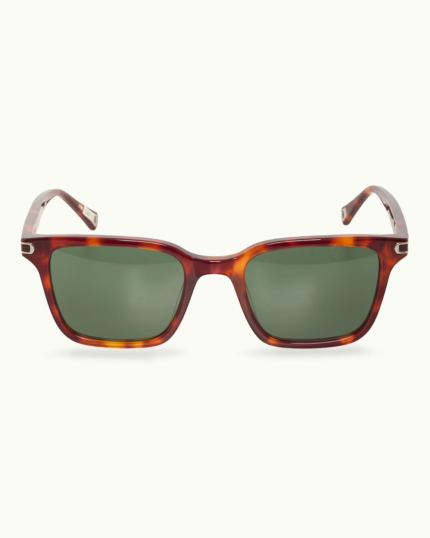 Sunglasses with tortoiseshell frame and green lenses on a white background